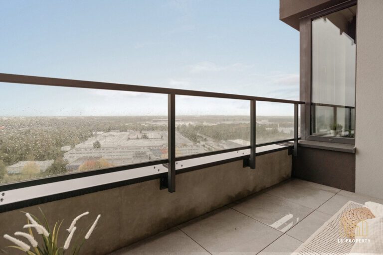 Balkon w mieszkaniu na wysokim piętrze z widokiem na miasto i przejrzystą balustradą.